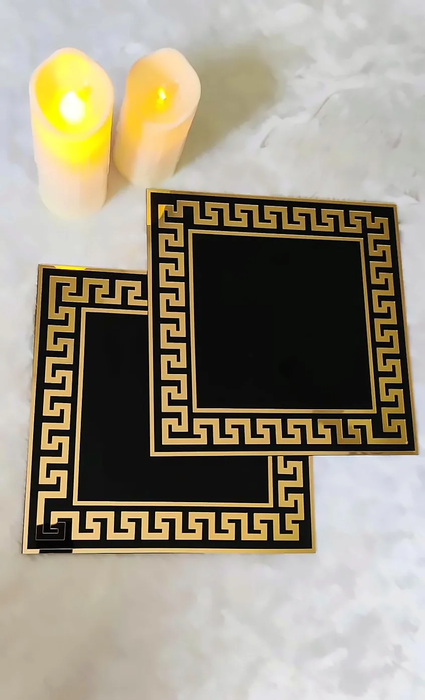 Black and gold Greek key square mats with candles